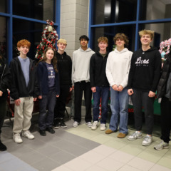 Members of Chelmsford High School's National Honor Society pose among the many donated items to be raffled off during the group's inaugural Festival of Trees.