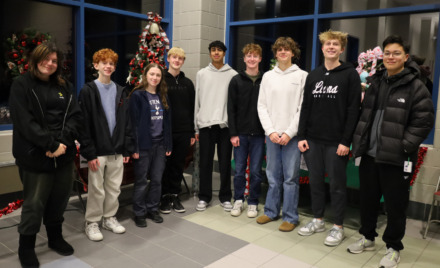 Members of Chelmsford High School's National Honor Society pose among the many donated items to be raffled off during the group's inaugural Festival of Trees.