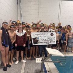 Chelmsford High boys swimming and diving coach Craig Vitale celebrates his 100th career win with his team.