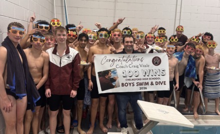 Chelmsford High boys swimming and diving coach Craig Vitale celebrates his 100th career win with his team.