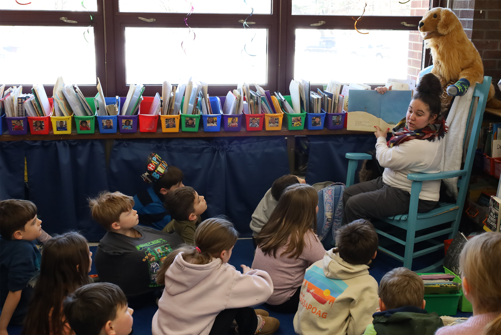 Dominique Rowe, a youth service specialist at Chelmsford Public Library, reads to students in Ms. Sullivan’s second grade class at Byam Elementary School on Wednesday, March 4.