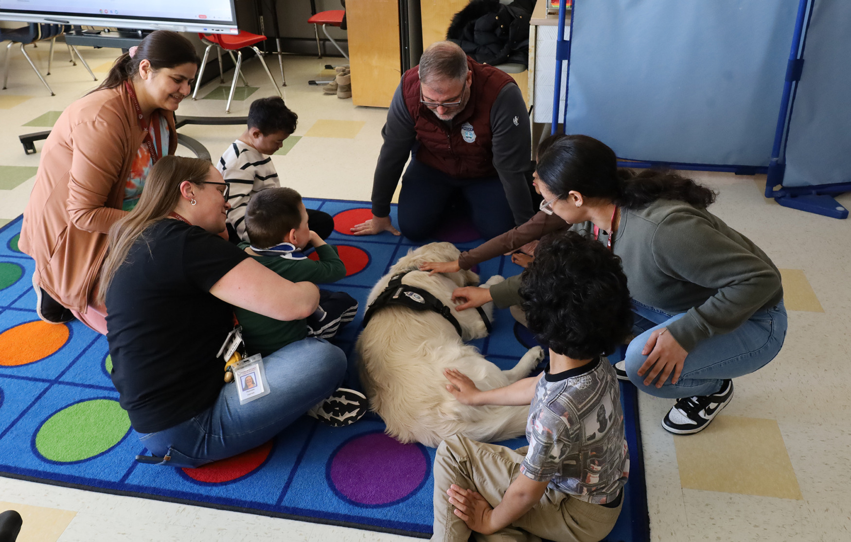 School Resource Officer Dan Sullivan and Ozzie visit with Ms. LaRochelle's kindergarten class at Center Elementary School during the annual Chelmsford Community Read-In on Wednesday, March 4.
