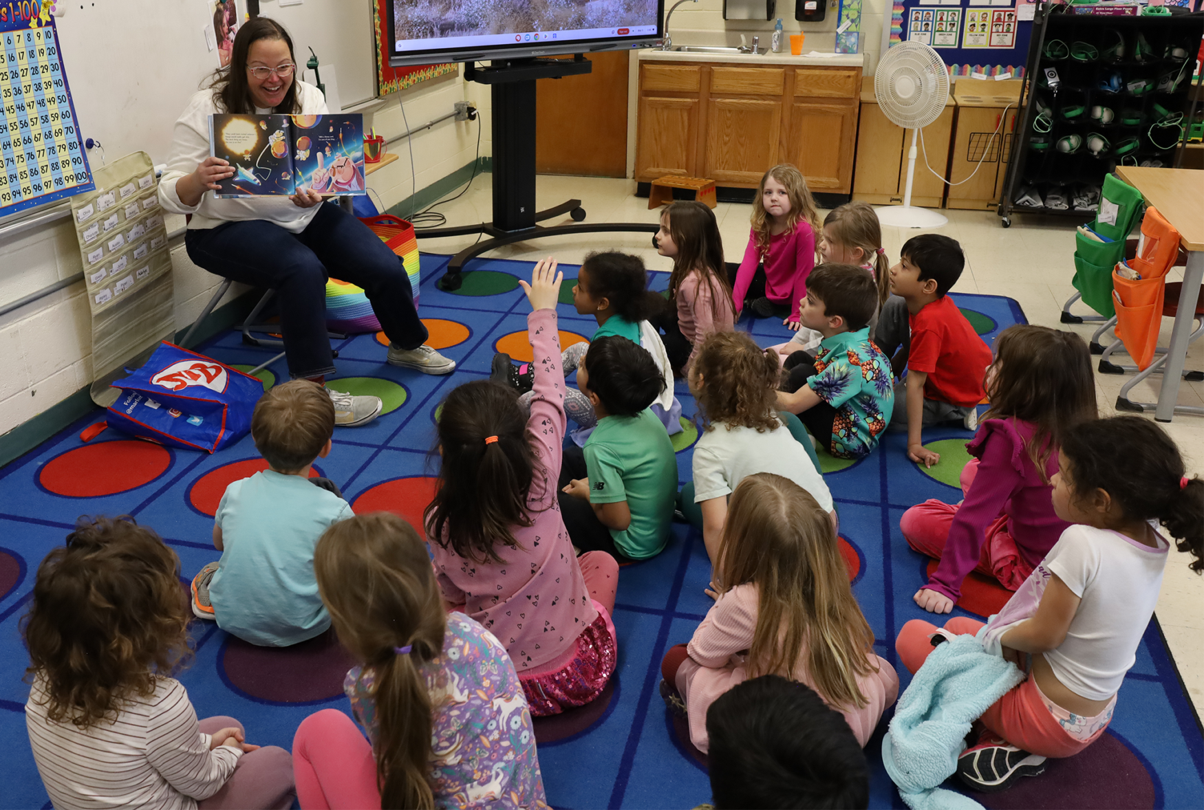 Stephanie Nelson, a youth services librarian at Chelmsford Public Library, reads “Never Give a Baby a Library Card” to Ms. Richman’s kindergarten class at South Row Elementary School during the annual Chelmsford Community Read-In on Thursday, March 5.