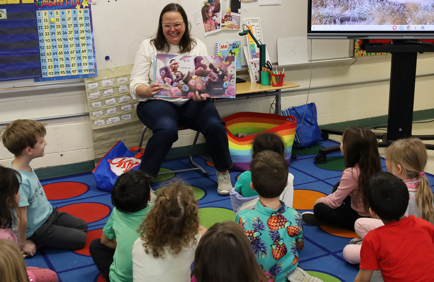 Stephanie Nelson, a youth services librarian at Chelmsford Public Library, reads “A Bear, a Man, and a Donut Van” to Ms. Richman’s kindergarten class at South Row Elementary School during the annual Chelmsford Community Read-In on Thursday, March 5.