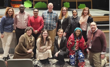 The 2026 Fulbright Teaching Excellence and Achievement (TEA) Fellows and their co-teachers pose for a photo in the Carl J. Rondina Performing Arts Center at Chelmsford High School.