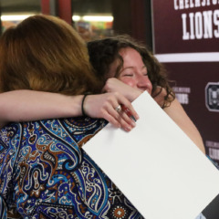 School Committee vice chair Susan Mackinnon, receives a hug from her former student Elizabeth Dunlea, a senior who is planning to study secondary education at Bridgewater State University.
