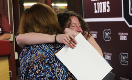 School Committee vice chair Susan Mackinnon, receives a hug from her former student Elizabeth Dunlea, a senior who is planning to study secondary education at Bridgewater State University.