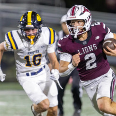 Chelmsford quarterback Skyler DeJesus gets past Andover’s Adrian Penney to pick up a first down during Friday’s MVC football game at Simonian Stadium in Chelmsford.