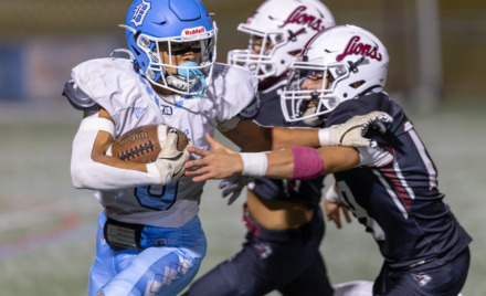 Dracut’s Phillip Dinh carries for a short gain before being tackled by Chelmsford defenders Aidan O’Donnell and Josh Valdez during Thursday’s MVC football game at Simonian Field in Chelmsford. Chelmsford captured a 25-0 win.